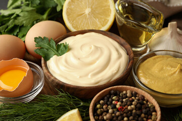 Wooden bowl of mayonnaise and ingredients for cooking