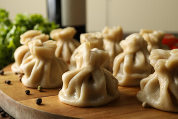 Concept of tasty lunch with board of khinkali, close up