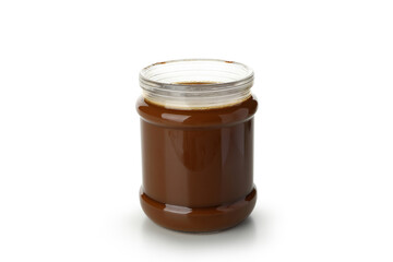 Glass jar with caramel condensed milk isolated on white background