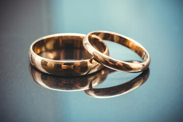 two traditional wedding gold engagement rings close-up