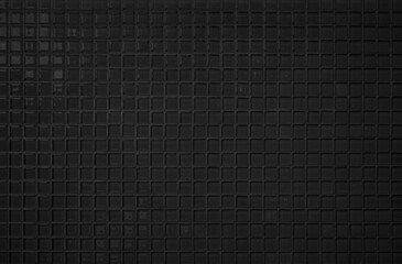 Black tile wall high resolution real photo or brick seamless  pattern and texture interior room background. Dark grid tiles wall texture for the decoration of the bedroom, Home or office backdrop.
