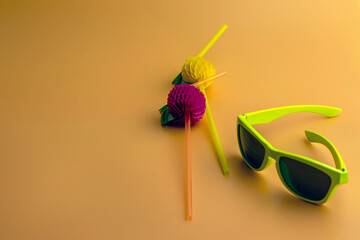 Flat accessories on a yellow background with cocktail tubes and sunglasses. Top view travel or vacation summer vacation concept.