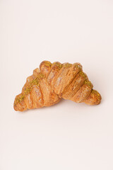 Tasty buttery croissants on the beige background. 