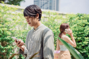 Handsome asian thai man talking on the phone outdoor.