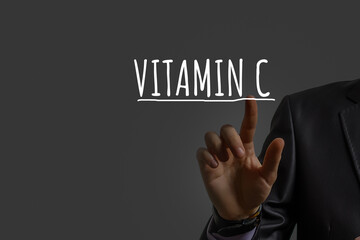 businessman's hand shows vitamin c