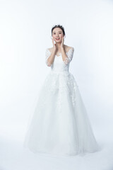 Fototapeta na wymiar Beautiful asian woman dressed as a bride on white background