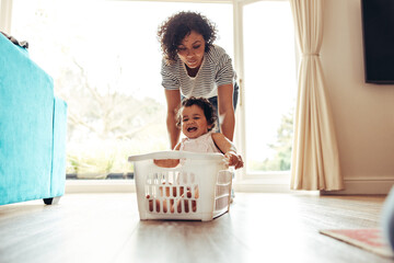 Baby enjoying laundry basket ride