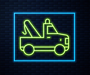 Glowing neon line Tow truck icon isolated on brick wall background. Vector.