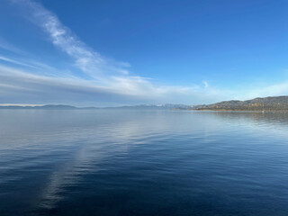 Landscape  view of clouds reflected in the calm blue waters of Lake Tahoe