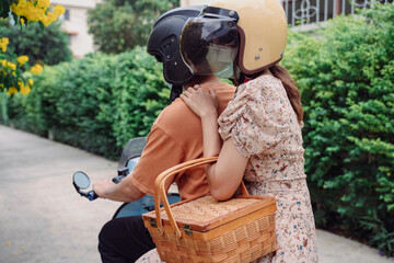 A motorbike taxi transports a passenger on a city street.