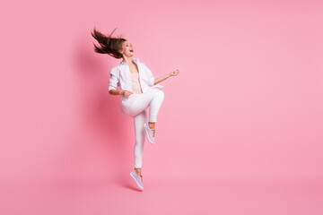 Full length photo of charming young woman dressed casual white clothes dancing looking empty space isolated pink color background