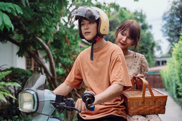Naklejka na ściany i meble Asian thai couple riding on classic vintage motor bike.