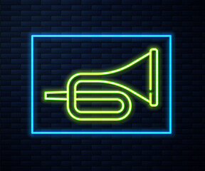 Glowing neon line Musical instrument trumpet icon isolated on brick wall background. Vector.