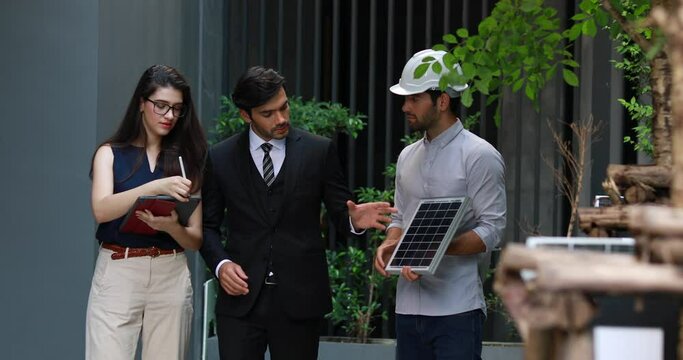 Young Executive CEO business man and woman secretary meeting with energy engineer plan a project to build a solar panel for the building under construction.