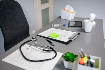 Doctor desk with medical documents and stethoscope