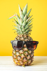 Pineapple with glasses summer on yellow background © Exploder
