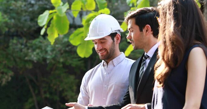Young Executive CEO business man and woman secretary meeting with energy engineer plan a project to build a solar panel for the building under construction.