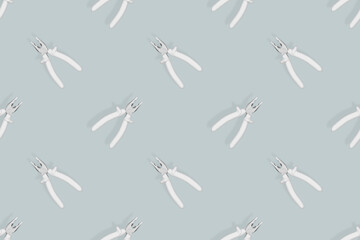 Pliers seamless pattern. Metal pliers with rubber grips.