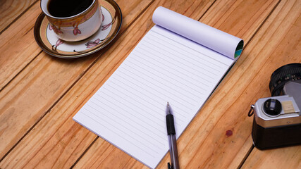 blank white paper notes with coffee and old camera on top wood table