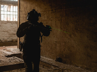 Silhouette of a special forces operator in abandoned building during his cqb tactical training.
