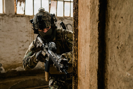 Special forces soldier doing tactical training in building clearing (CQB). He is wearing multicam uniform and assault rifle HK416.