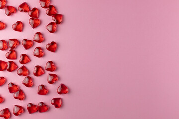 Valentine's day background of red hearts on pink backdrop. Holiday, father and mother day, background and postcard. Copy space