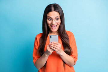 Photo of astonished lady open mouth unbelievable comment wear eyeglasses isolated on blue color...