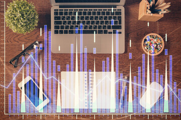 Stock market graph and top view computer on the table background. Multi exposure. Concept of financial education.