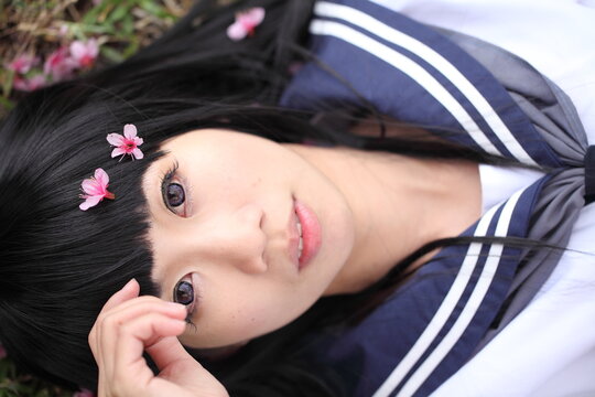 Directly Above Portrait Of Woman With Flowers Relaxing In Park