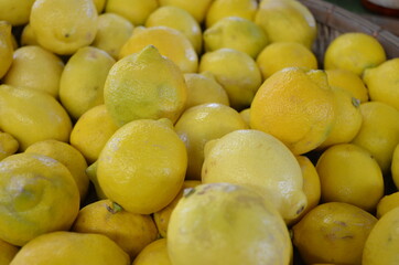 Piles of Bright Yellow Lemons for Sale at Outdoor Market