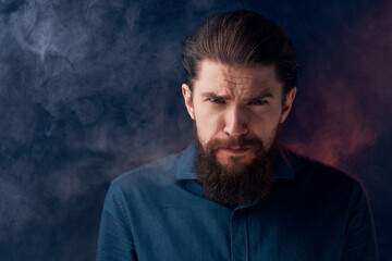 Emotional man black shirt attractive look close-up smoke in the background