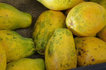 Yellow and green ripe papaya at an outdoor market