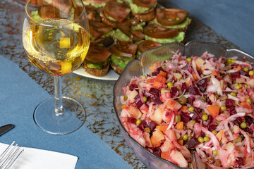 Wine salads and snacks on the festive table.