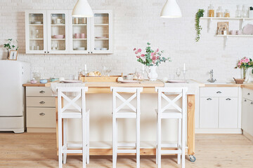 White kitchen in interior loft style. Valentine's day kitchen decor. Kitchen utensils and shelves.