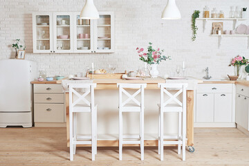 White kitchen in interior loft style. Valentine's day kitchen decor. Kitchen utensils and shelves.