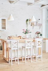 White kitchen in interior loft style. Valentine's day kitchen decor. Kitchen utensils and shelves.