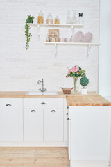 White kitchen in interior loft style. Valentine's day kitchen decor. Kitchen utensils and shelves.
