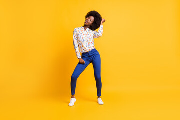 Fototapeta na wymiar Full length photo of pretty cute dark skin lady dressed casual outfit dancing smiling isolated yellow color background