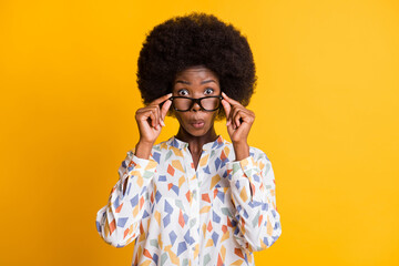 Photo of funny surprised dark skin lady dressed casual outfit arms hands eyewear isolated yellow color background