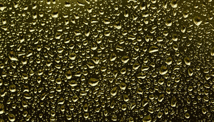 Trendy Color of the year 2021 Illuminating yellow. The texture of rain drops on the glass close-up. Macro transparent water drops on dark background.