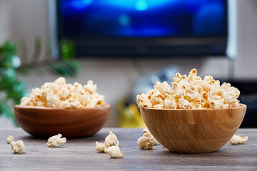 Two wooden bowls with fresh popcorn