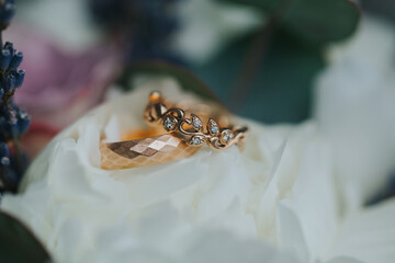Beautiful wedding rings on flower bouquet-details. 