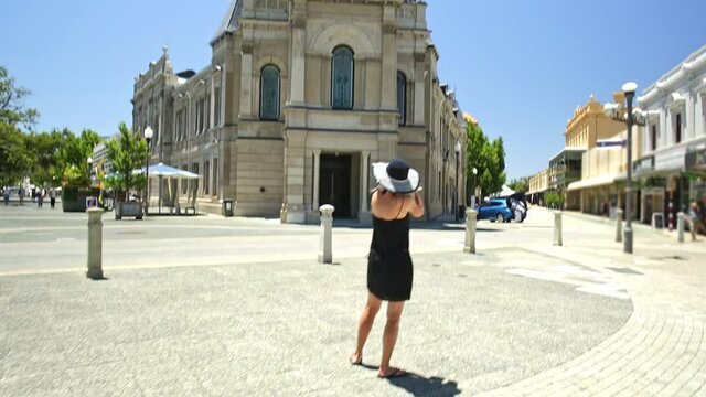 photographer woman at Fremantle town hall situated on corner of High, William and Adelaide Streets and is part of optical illusion artwork in West End Heritage. Fremantle in Western Australia