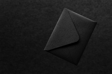 Black paper envelope on black background
