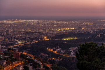 Barcelona city night view lights on top of Mount Tibidabo at blue hour