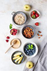 Fototapeta na wymiar Healthy diet. Oatmeal. Ingredients for porridge. Wholesome breakfast. Delicious summer berries. Useful nuts.