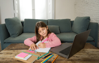 School girl with laptop studying online at home as school is closed due to new COVID-19 Lockdown