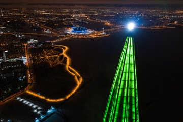 Aerial view of the night Lakhta center in green color in St. Petersburg, on the shore of the Gulf of Finland.
