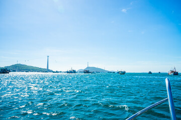Hon Thom island in Phu Quoc, Vietnam, Asia - Tropical view with colorful houses, blue waves and blue sky, fishing boats and far away is a longest cable car