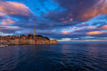Wonderful morning view of old  Rovinj town with multicolored buildings and yachts moored along...